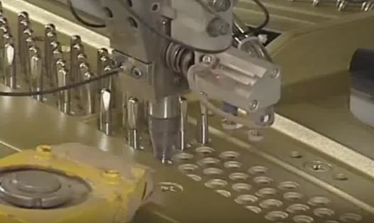 Pins being placed with industrial robot in upright piano